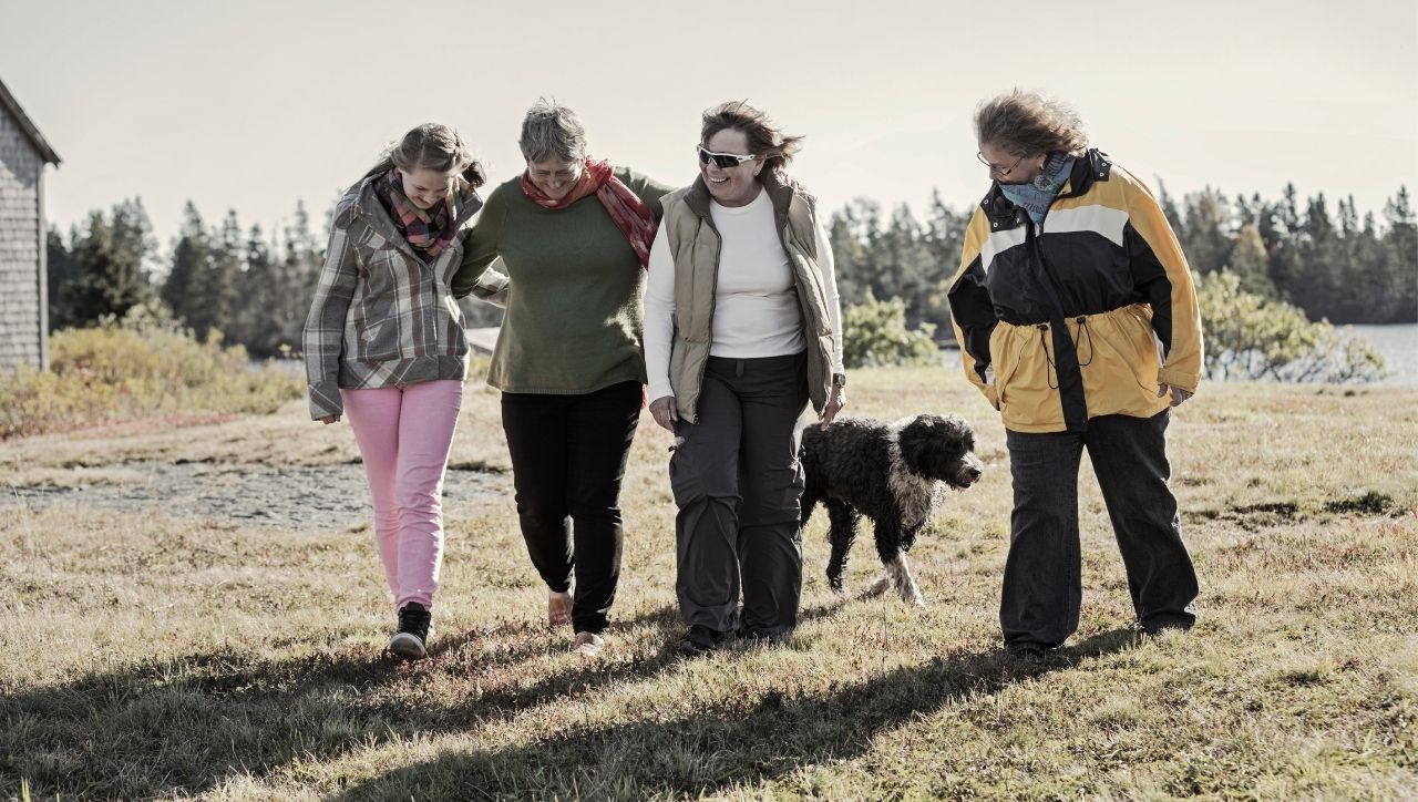 adult children and mother walking