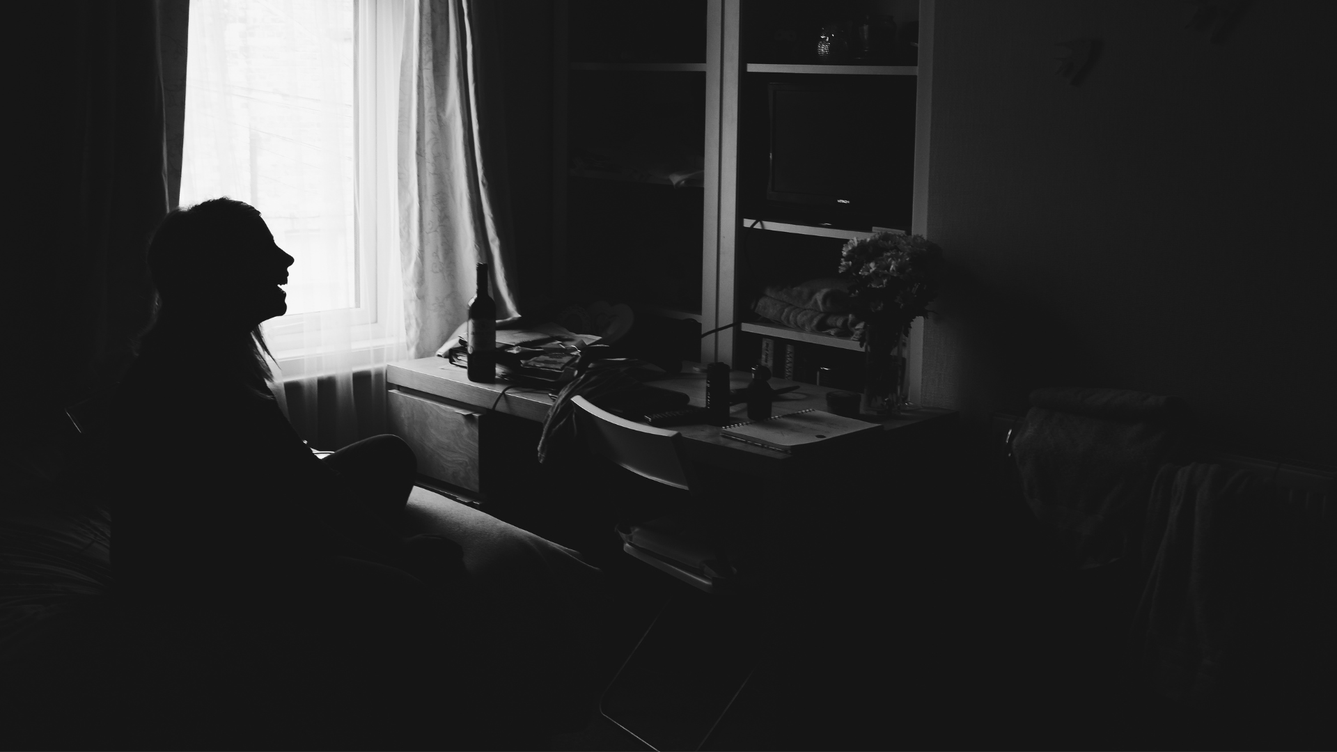 Older woman in her dimly lit house